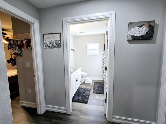 bathroom with vanity, hardwood / wood-style flooring, and toilet