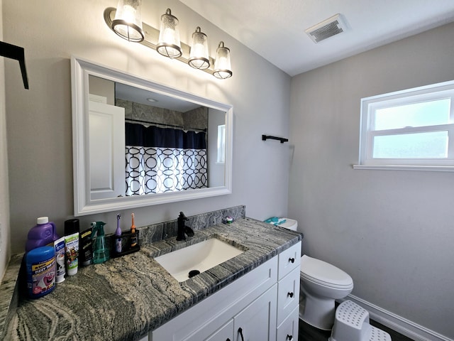 bathroom with vanity and toilet