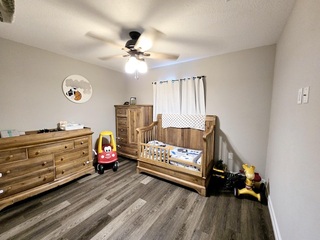 bedroom with hardwood / wood-style floors, a textured ceiling, and ceiling fan