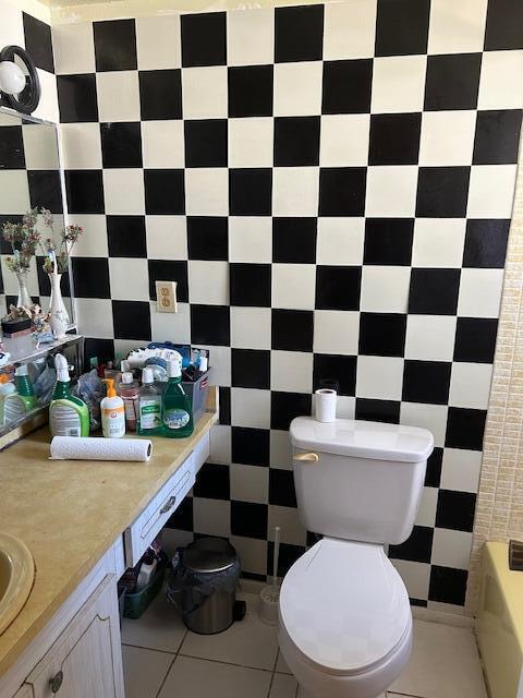 bathroom featuring tile patterned floors, vanity, and toilet