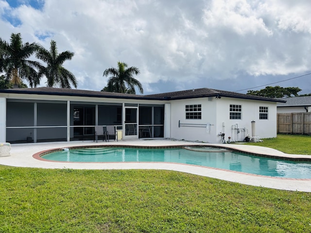 view of pool featuring a sunroom, a patio, and a lawn