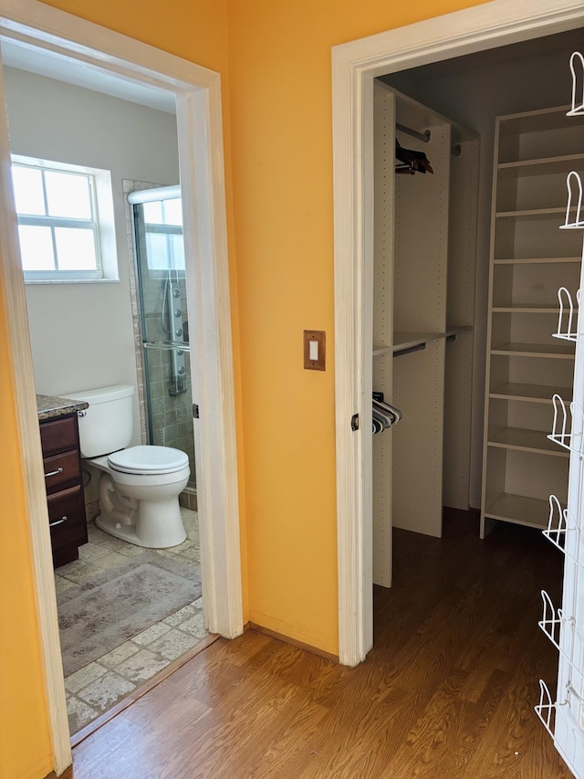 bathroom with hardwood / wood-style flooring and toilet