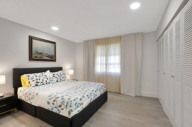 bedroom featuring light wood-type flooring and a closet