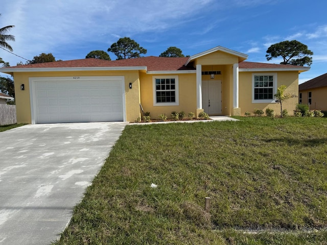 ranch-style home featuring a garage and a front lawn