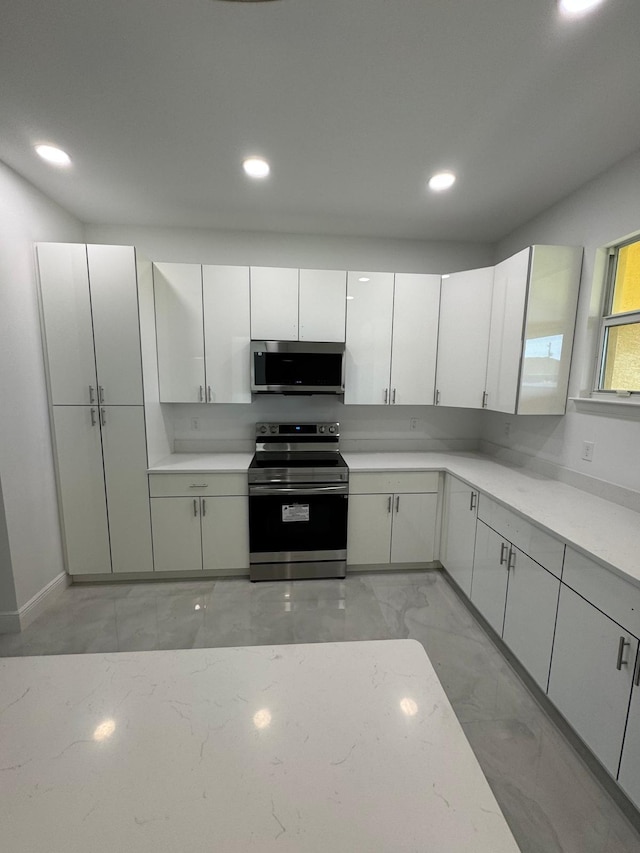 kitchen featuring white cabinets and stainless steel appliances