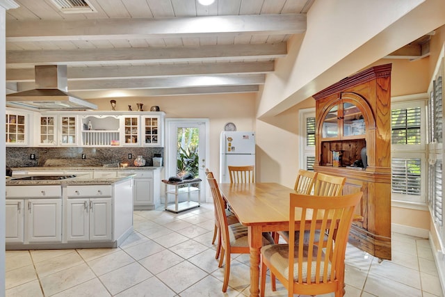 dining room featuring light tile patterned floors, wooden ceiling, and beamed ceiling