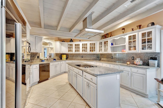 kitchen featuring white cabinets, black appliances, a kitchen island, and decorative backsplash