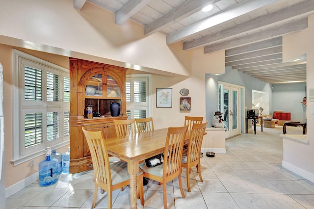 tiled dining room featuring a wealth of natural light, french doors, and beam ceiling