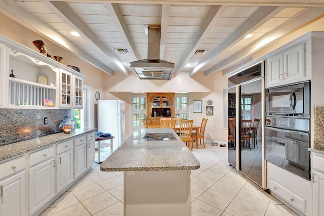 kitchen with white cabinetry, black appliances, and a center island