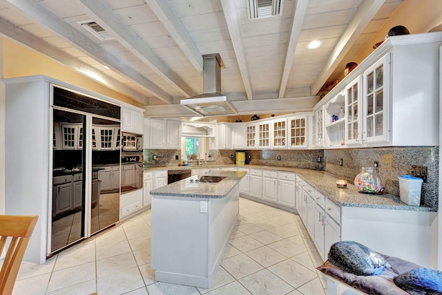 kitchen featuring white cabinetry, a center island, black appliances, tasteful backsplash, and light stone counters