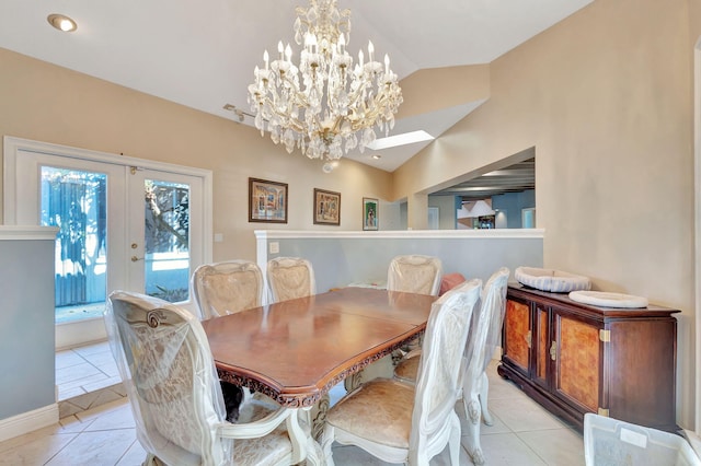 dining room with lofted ceiling, french doors, and light tile patterned floors