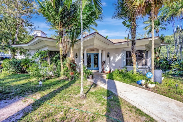 view of front of property with french doors and a front yard