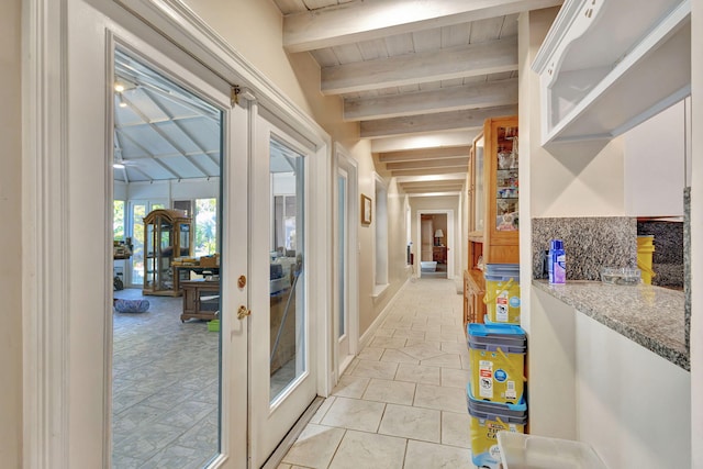 hall featuring french doors, beamed ceiling, and light tile patterned floors