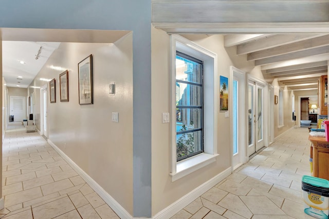 hall with beam ceiling and light tile patterned floors