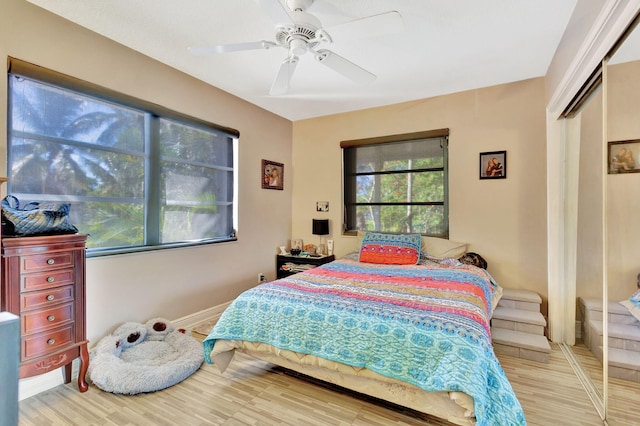 bedroom featuring a closet, ceiling fan, and light hardwood / wood-style flooring