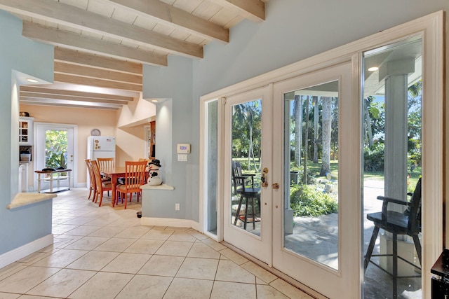 doorway featuring light tile patterned floors, plenty of natural light, french doors, and beam ceiling