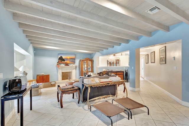 dining space with light tile patterned floors, wooden ceiling, and beam ceiling