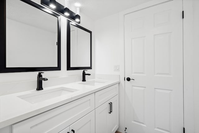 bathroom with vanity and a textured ceiling