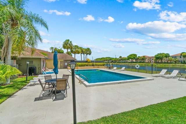 view of pool featuring a patio area and a water view