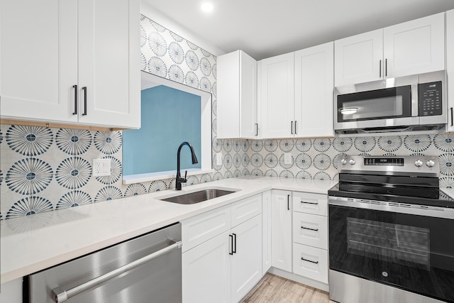 kitchen featuring sink, white cabinetry, and stainless steel appliances