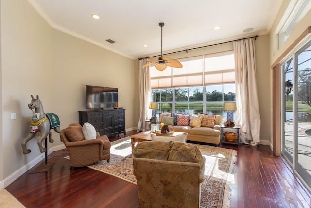 living room with ornamental molding, dark hardwood / wood-style floors, and ceiling fan