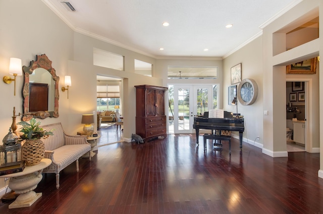 sitting room with dark wood-style floors, baseboards, ornamental molding, and french doors