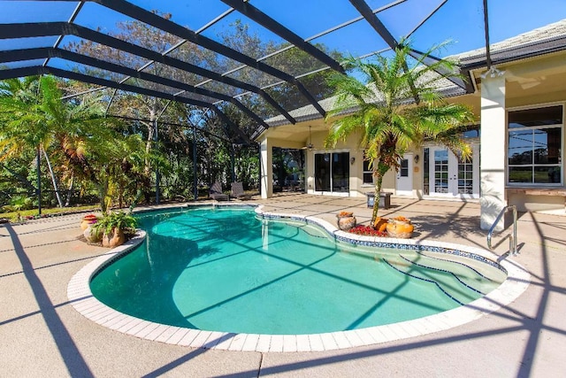 view of swimming pool with french doors, ceiling fan, a patio area, and glass enclosure