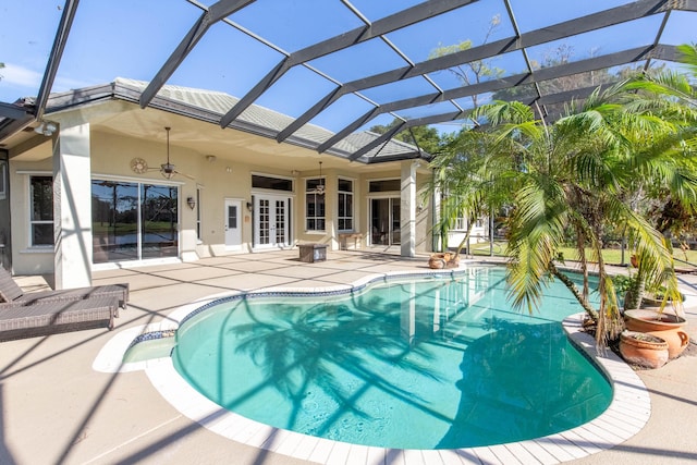 view of pool featuring french doors, ceiling fan, a lanai, and a patio