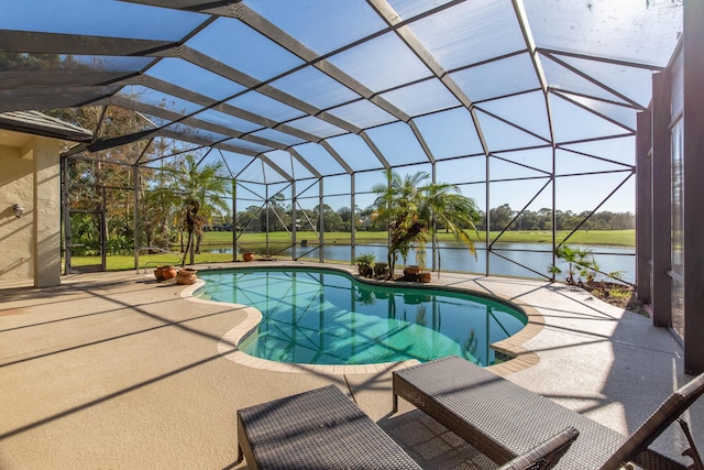 view of pool featuring a water view, glass enclosure, and a patio area