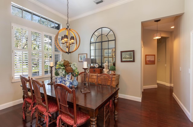 dining space with dark hardwood / wood-style flooring, a notable chandelier, and ornamental molding