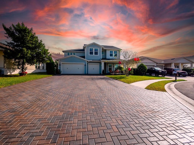 front of property featuring a lawn and a garage