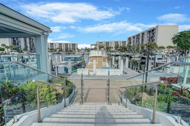 exterior space with a water view and a dock