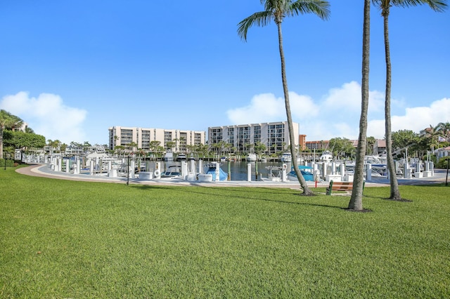 exterior space featuring a water view, a dock, and a lawn