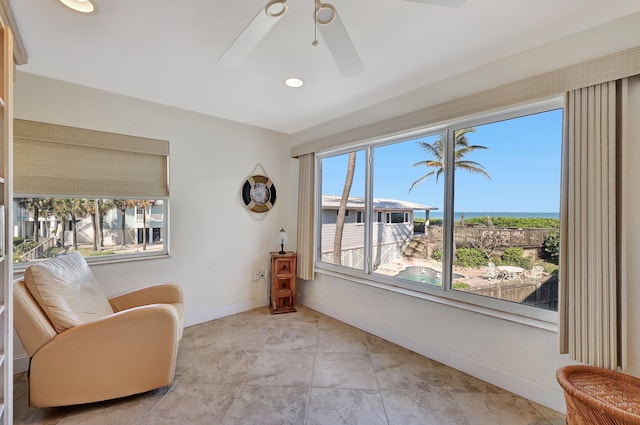 living area with ceiling fan