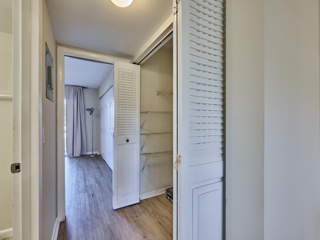 hallway with light hardwood / wood-style floors