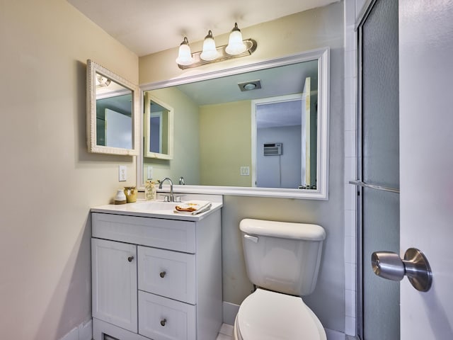 bathroom featuring vanity, a wall mounted air conditioner, and toilet