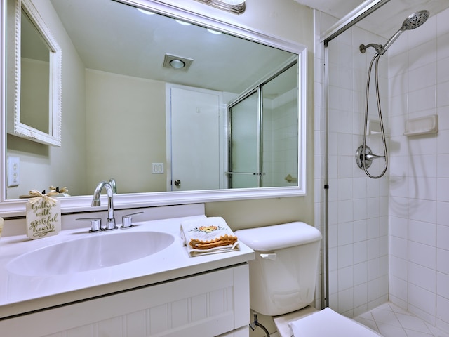 bathroom featuring vanity, toilet, and walk in shower