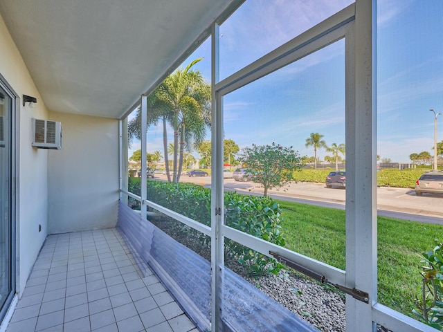 unfurnished sunroom with an AC wall unit