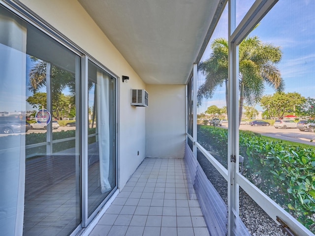 unfurnished sunroom with an AC wall unit