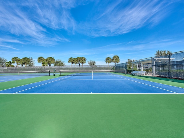 view of tennis court with basketball hoop