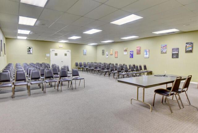 interior space with carpet flooring and a drop ceiling