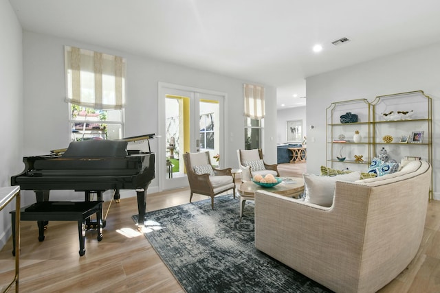 living area featuring french doors and light hardwood / wood-style flooring