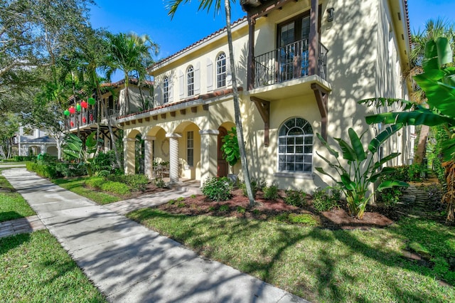 mediterranean / spanish home with a front yard