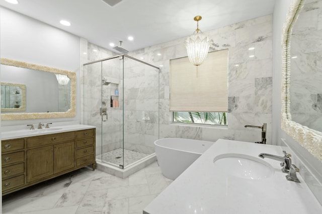 bathroom featuring tile walls, vanity, a notable chandelier, and shower with separate bathtub