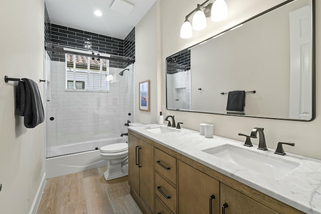 full bathroom with vanity, toilet, combined bath / shower with glass door, and wood-type flooring