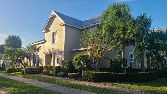 view of side of property with a lawn