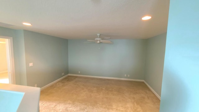 carpeted empty room with ceiling fan