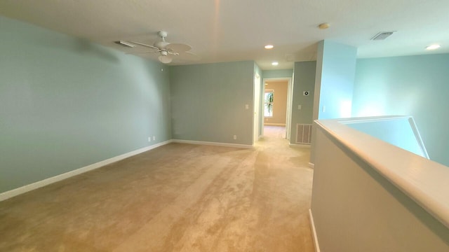 carpeted empty room featuring ceiling fan