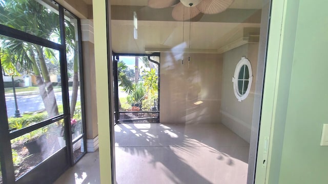 unfurnished sunroom with ceiling fan