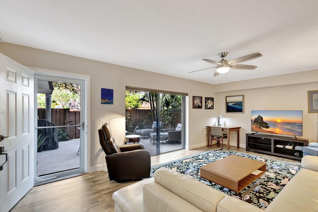 living room with ceiling fan and light hardwood / wood-style floors